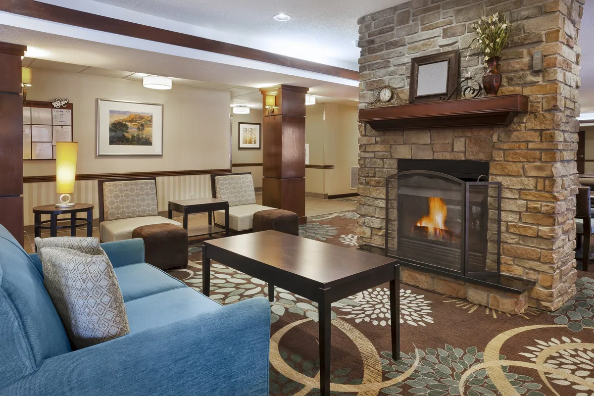 A cozy interior lounge featuring a fireplace, comfortable seating, and tasteful decorative elements. The mood is warm and inviting, perfect for relaxing after a day of sightseeing, sharing stories, or enjoying a quiet moment with a warm drink.